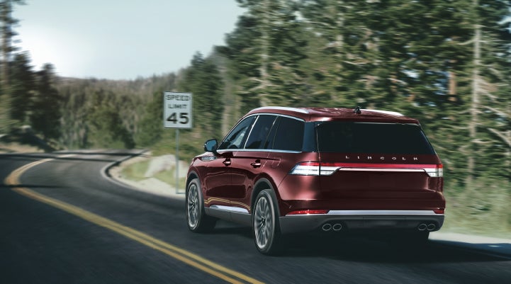 A 2024 Lincoln Aviator® SUV is being driven on a winding mountain road | West Point Lincoln in Houston TX